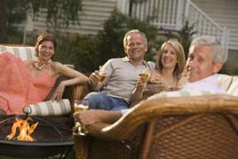 Enjoying a drink with friends around an outdoor fire pit