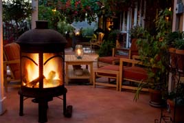 Wood burning fire pit adds warmth and light to this outside patio